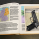 A gun inside of a hollowed-out textbook.